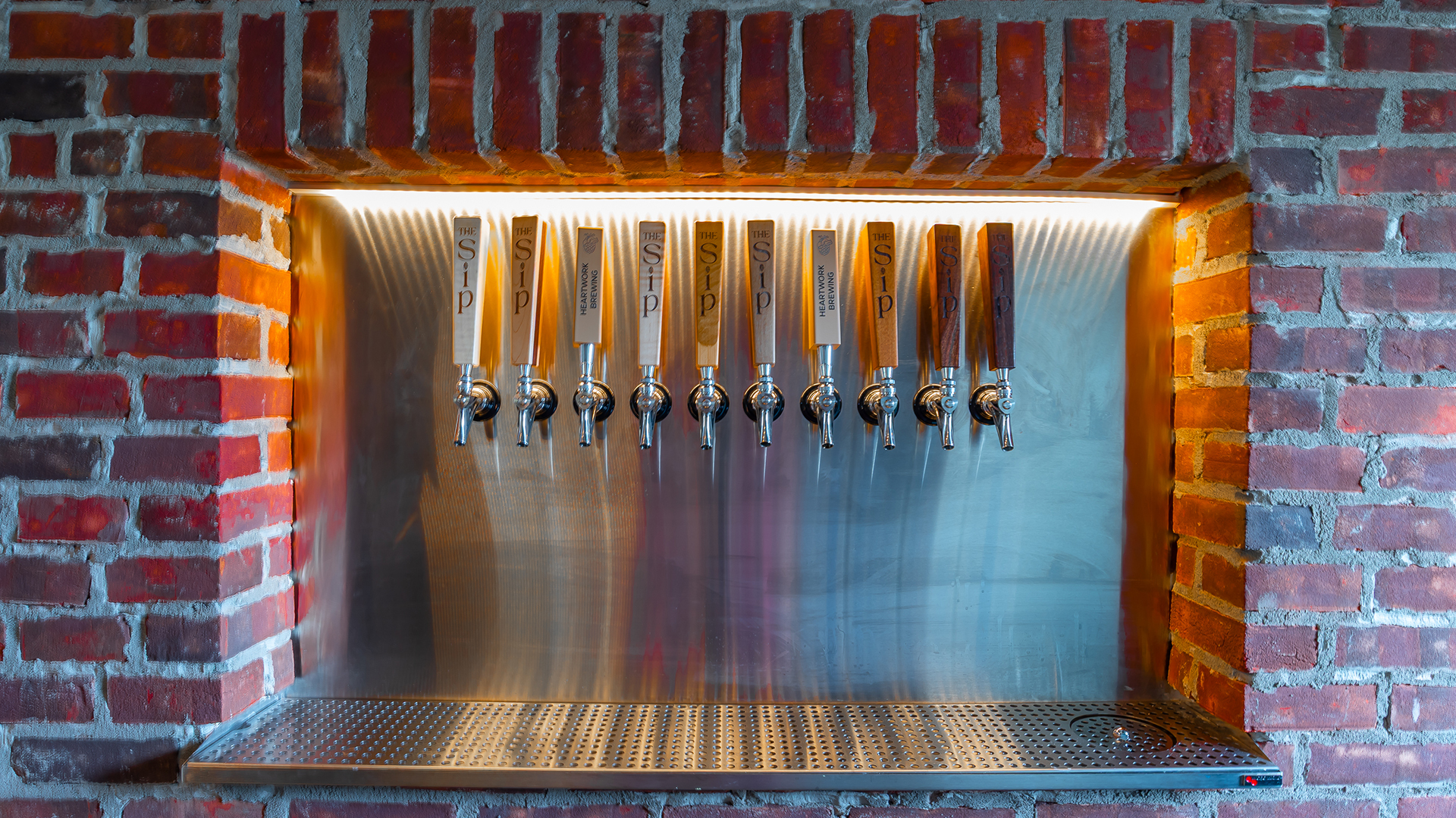 Custom wood tap handles at The Sip Craft Beer Pub